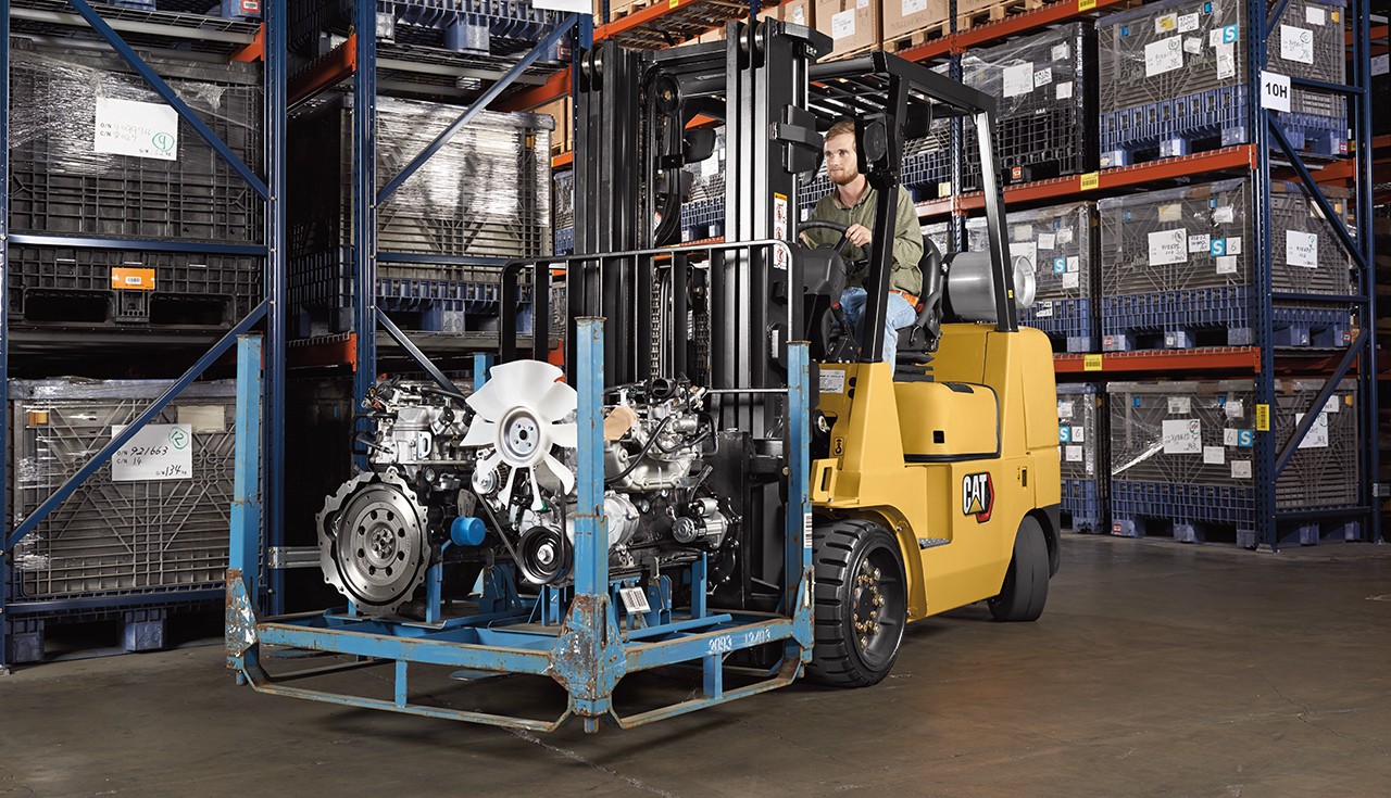 Cat forklift in warehouse with specialty attachment