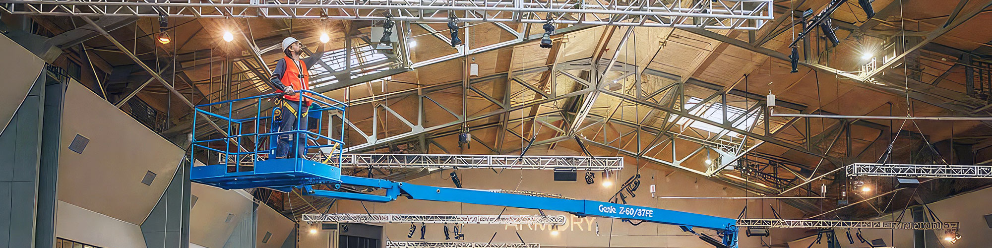 Genie articulated boom lift being used to change light